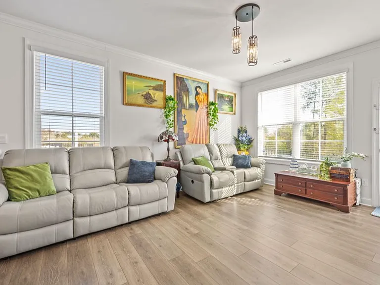 Spacious living room area with lots of natural light. Living room area opens to the backyard.