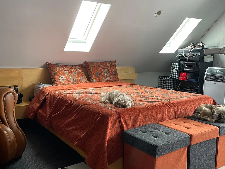 Queen size bed with Summer bedding.