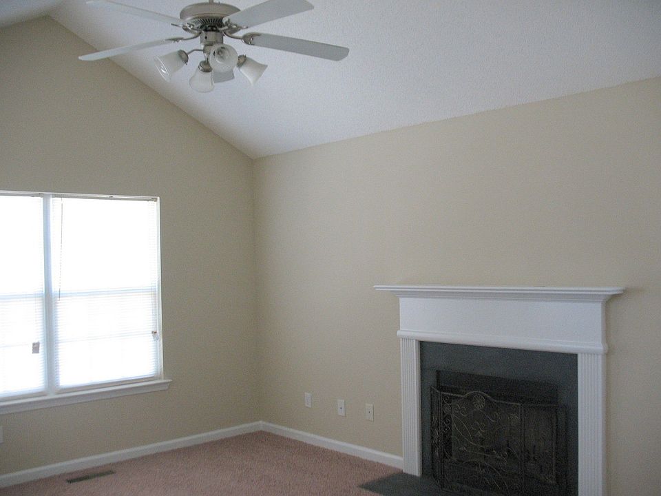 large living room w. cathedral ceiling and fireplace