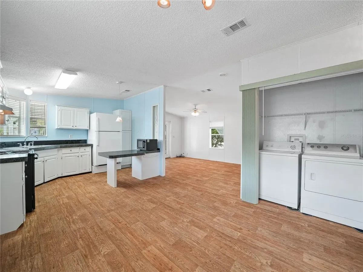 Kitchen and laundry area viewed from dining room. Open floor plan - 4 Stonefly Cir