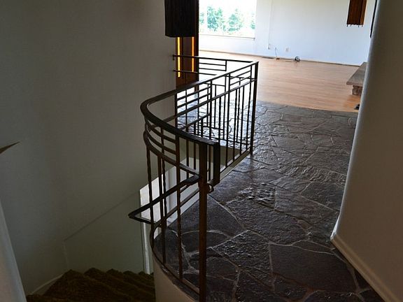 Stylish open staircase to finished lower level. Nice open circular floor plan!