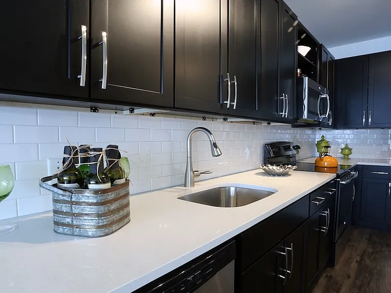 Sleek subway tile backsplash and dark wood cabinets
