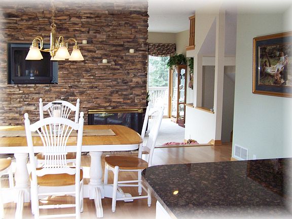 Three sided fireplace, between kitchen and Great Room!