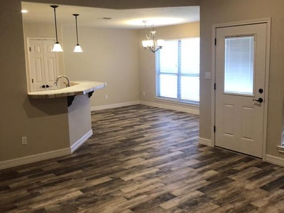View from living room of back door and dining area