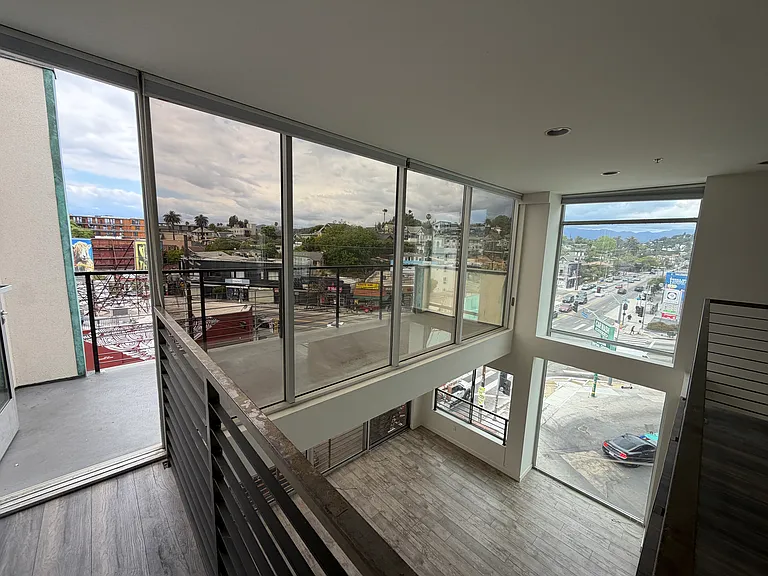 View to large private balcony and double height space below