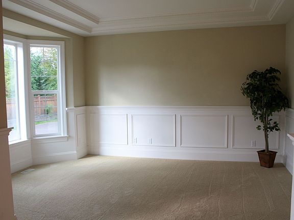 Chair rail, wainscoting, crown moulding, & coffered ceilings in formal living.