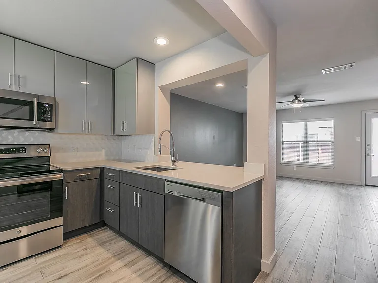 Cook in style with stainless appliances, sleek cabinetry, and quartz counters.