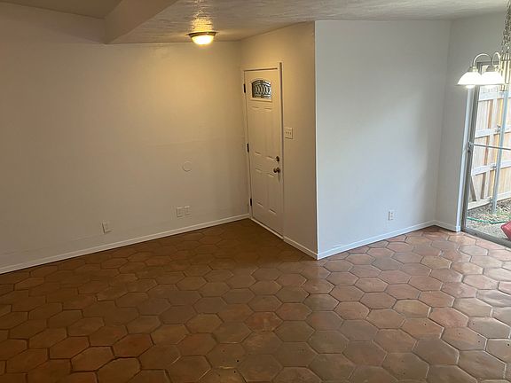 View from the hallway/living room to the front door/dining room.