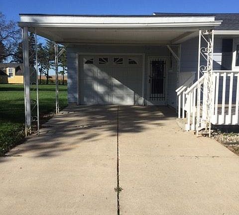 Single car attached garage w/ carport