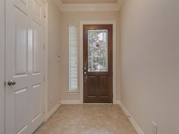 Entry way with beautiful front door and tile flooring