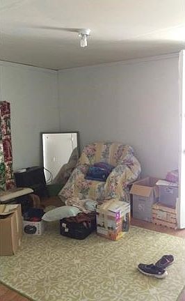 bedroom at the back of house with door to outside.