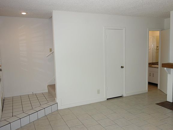 Living Room - Front door on the left, understairs storage, and half bath.