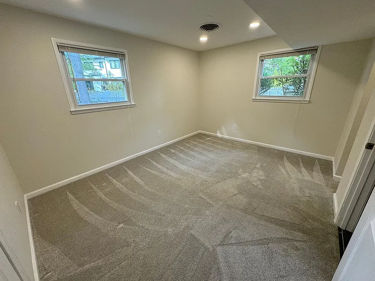 Lower level bedroom with new carpet, walk-in closet, and direct bathroom access.