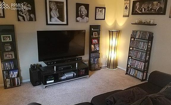 Carpeted Living Room with easy access to kitchen, bedrooms and downstairs in this tri-level floor plan