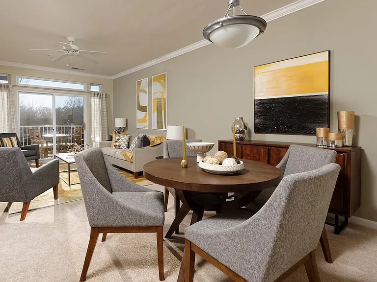 Classic Package I living and dining areas with ceiling fan and carpeted flooring