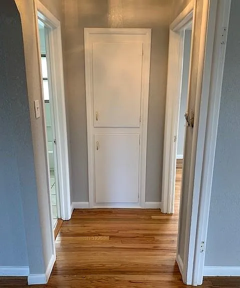 hallway showing built-in storage cabinets