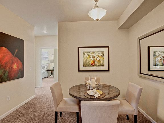 A cozy dining area with overhead lighting and easy access to the kitchen