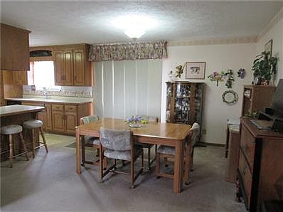 The dining area is open to the kitchen and family room and the doors lead to the spacious backyard.