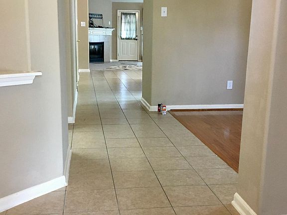 Front entry with dining and second living area to the right of the entry. The hall continues forward to the kitchen and living room on the right with the bedrooms on the left.