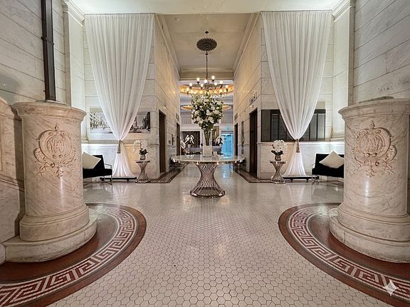Gorgeous lobby with original historic flooring and marble staircase
