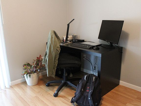 Desk and chair make a great working area near sliding door overlooking courtyard.