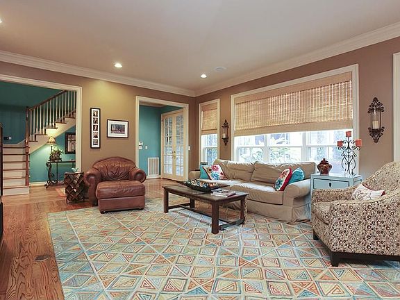 Another view of the living room and foyer beyond.