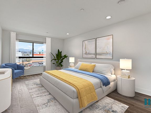 Spacious Bedroom with Vinyl Flooring, Recessed Lighting, and Large-Size Windows