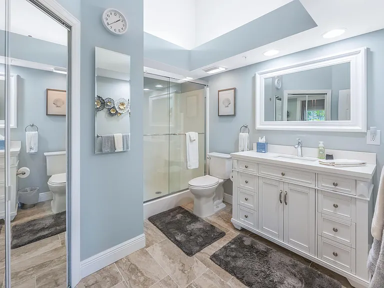Ensuite master bath with walk in shower and walk in closet with mirrored doors.