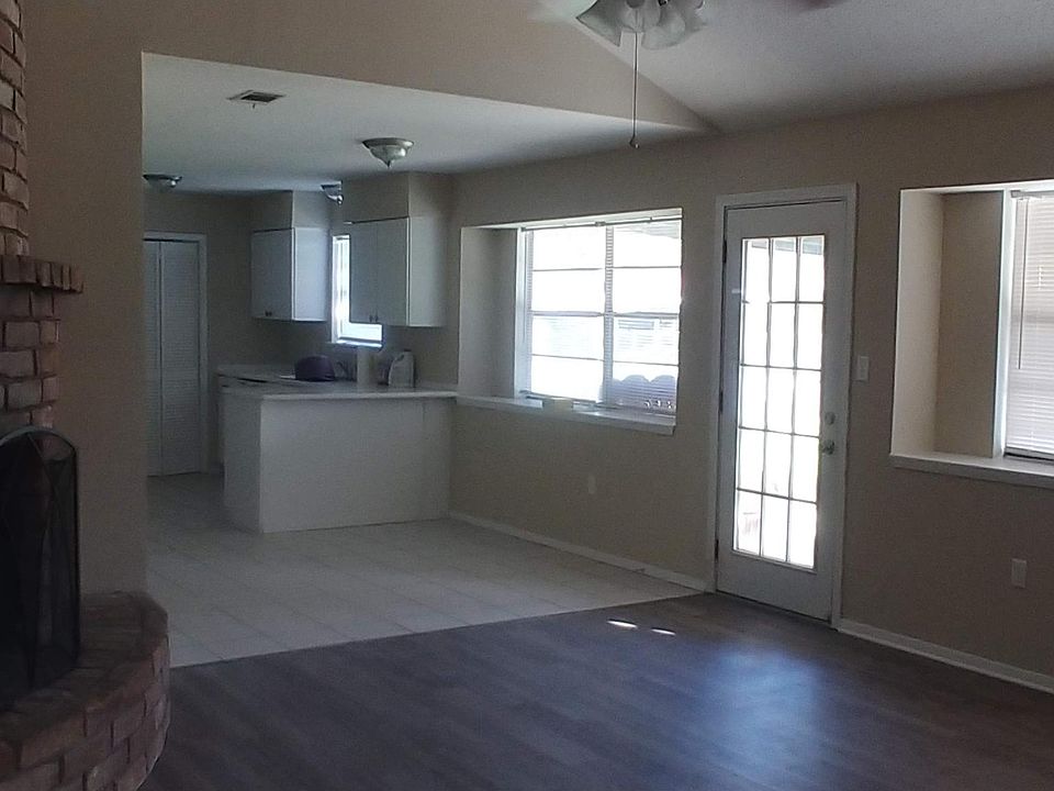 Living room fireplace looking into kitchen area.