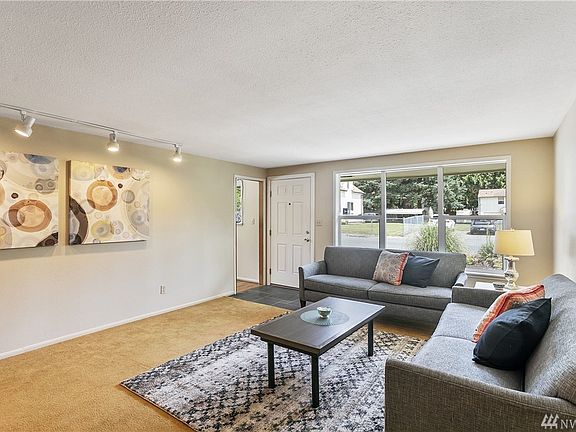 Here's another view of the living room looking back toward the entry. The entry features slate tile flooring.