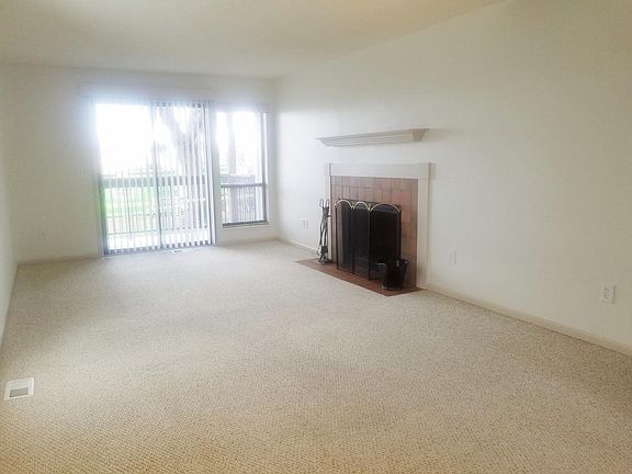 Large living room with walk out patio, fireplace, natural li