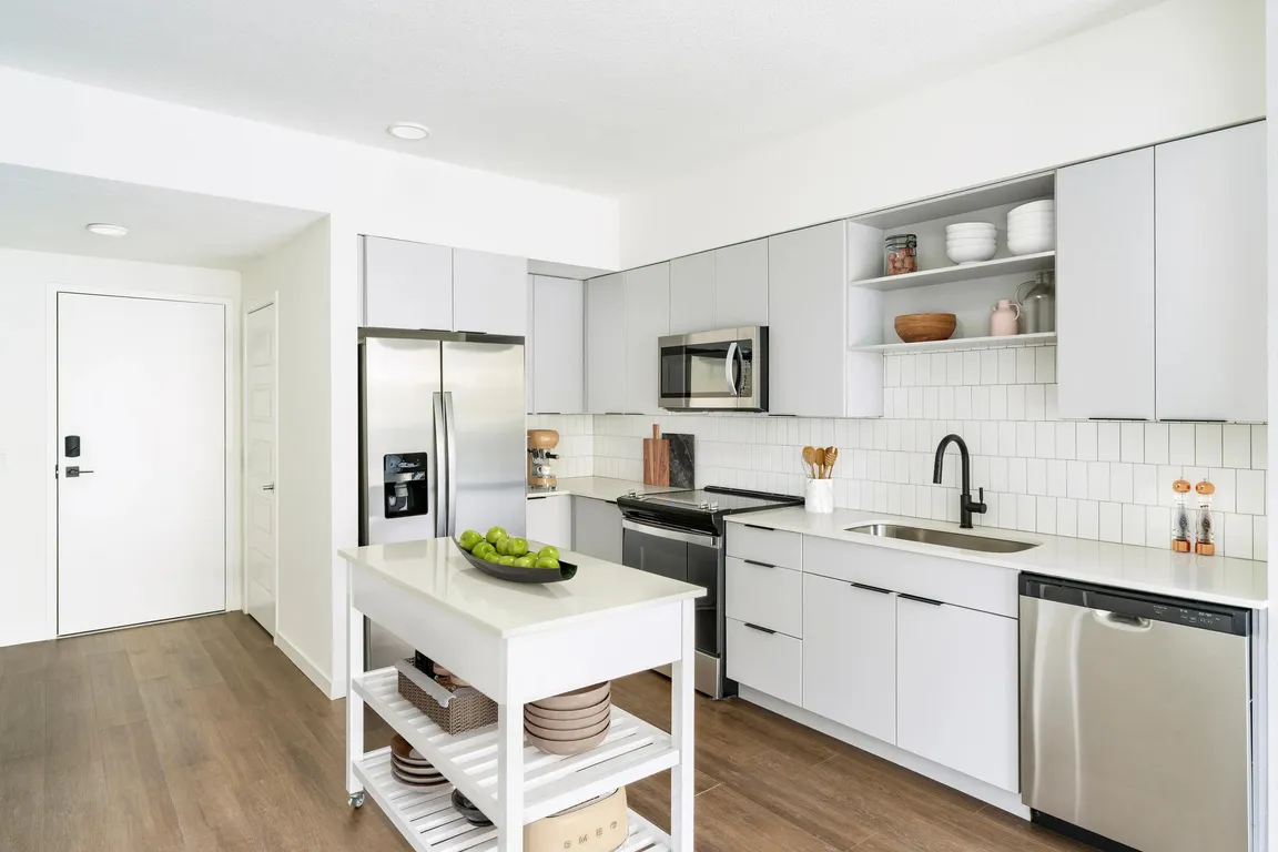 A light-cabinet kitchen with a movable island offers flexible, effortless living throughout your Modera Encore Tampa home.