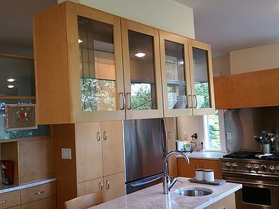 hanging built in cabinets above the marble island.