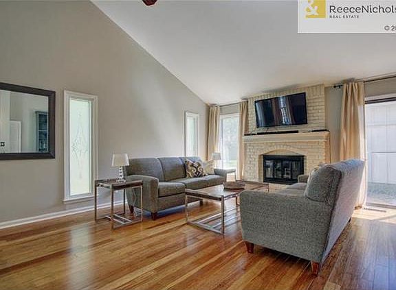 Living Room w/ bamboo hardwoods and painted brick fireplace.