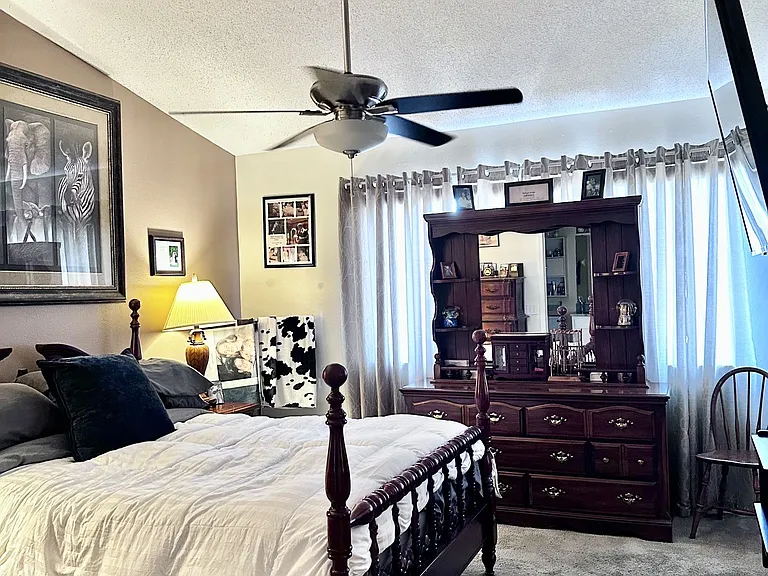 Bedroom with newer carpeting and vaulted ceilings, lots of light through large windows with pond view. Ensuite bathroom as well