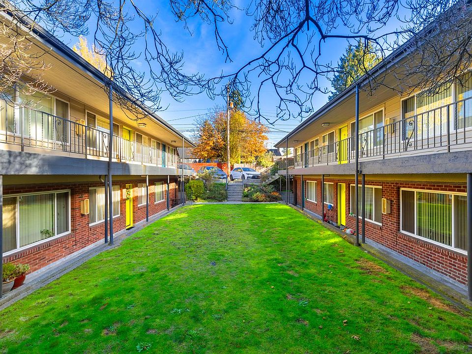Slightly warmer/promotional: Welcoming courtyard bordered by both buildings, viewed from the California Ave SW end of the property