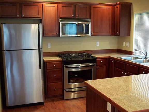 Kitchen: stainless steel appliance, cherrywood cabinets, granite tile counters