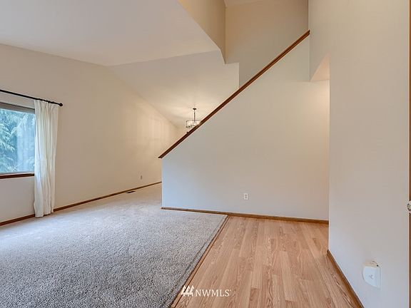 Enter to vaulted ceilings, this living room to dining room combo is filled with light