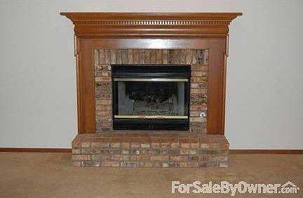 Wooden Mantle with brick accents : This is nice place to sit on those cold evenings.