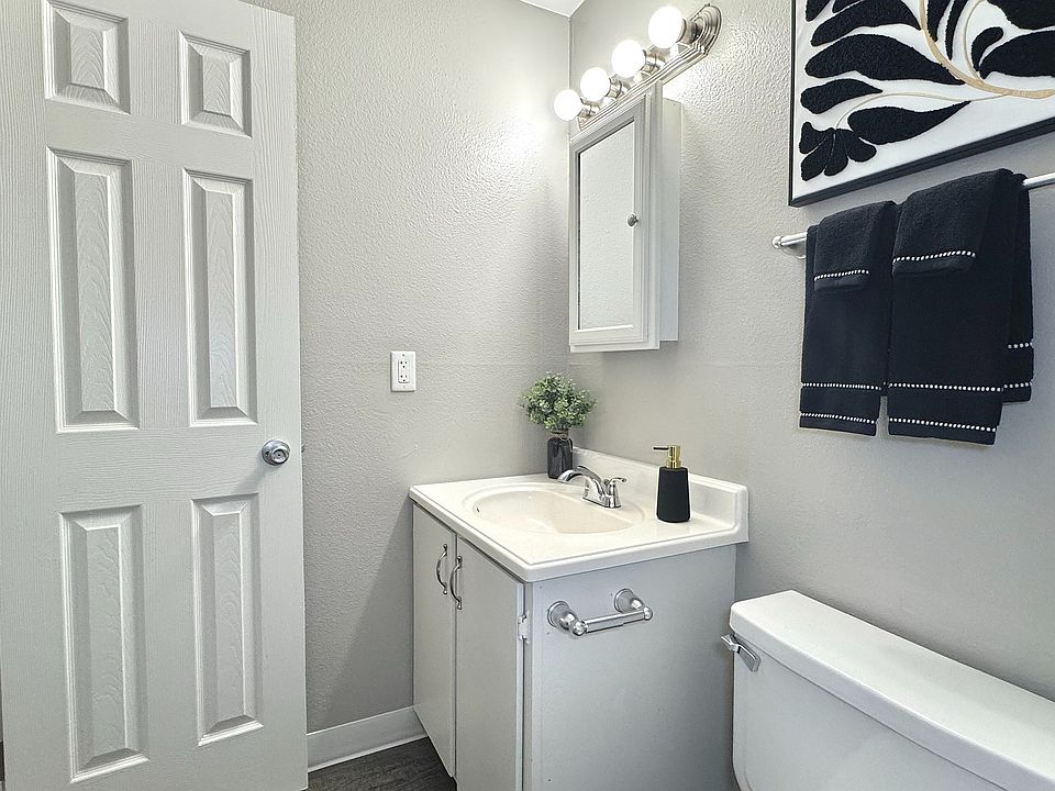 Sleek modern bathroom with a pristine bathtub, stylish vanity, and bright lighting.