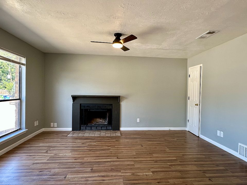 Living room with ample natural light and cozy fireplace