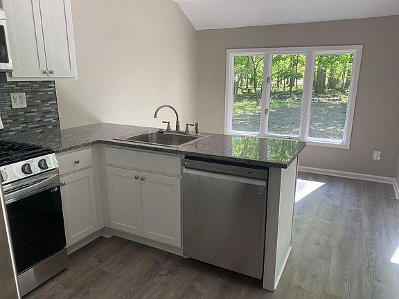 Large eat-in kitchen with LG stainless steel appliances and granite counter tops.