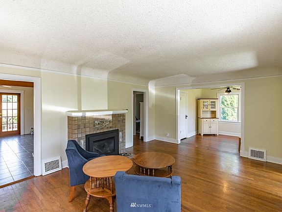 Living Room with original Fir Floors! Gas Fireplace to keep cozy in the cold months.