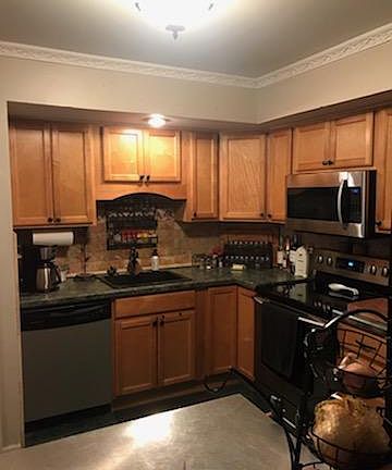 View 2 of kitchen. Dishwasher, tile back-splash, beautiful granite counter top.