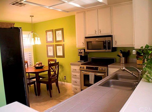 Stainless Steel Appliances, Ceramic Tile Counter, Double Stainless Steel Sinks With Faucet Wand