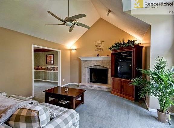 Great room with stone fireplace.  Cathedral ceiling.