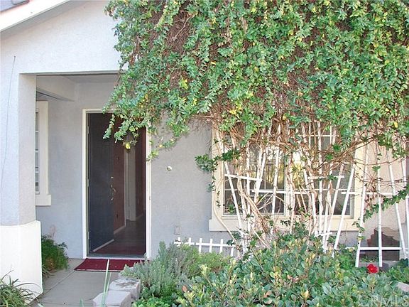 FRONT PORCH & ENTRY AND LIVING ROOM IS SHADED FROM SUMMER MORNING SUN BY TRELLIS . PERFECT FOR SITTI