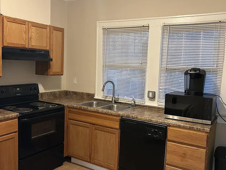 Functional kitchen with a full appliance set for easy meal preparation including a Keurig coffee maker.