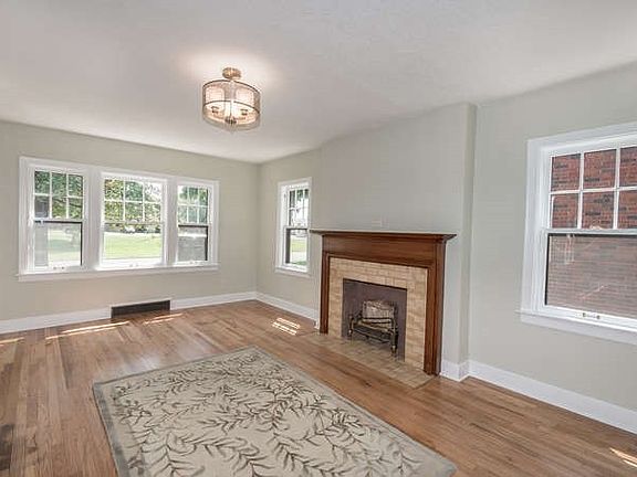 New exterior door into the living room. Hardwood floors were refinished. New lighting. New paint on ceiling, walls and trim. Original fireplace is decorative only.  Seller believes tile on fireplace is also 1940 original. Charm throughout the house.