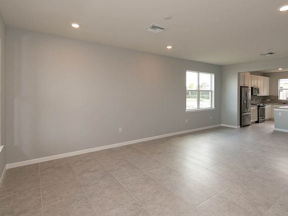 Spacious gathering room with tile floors and LED lighting